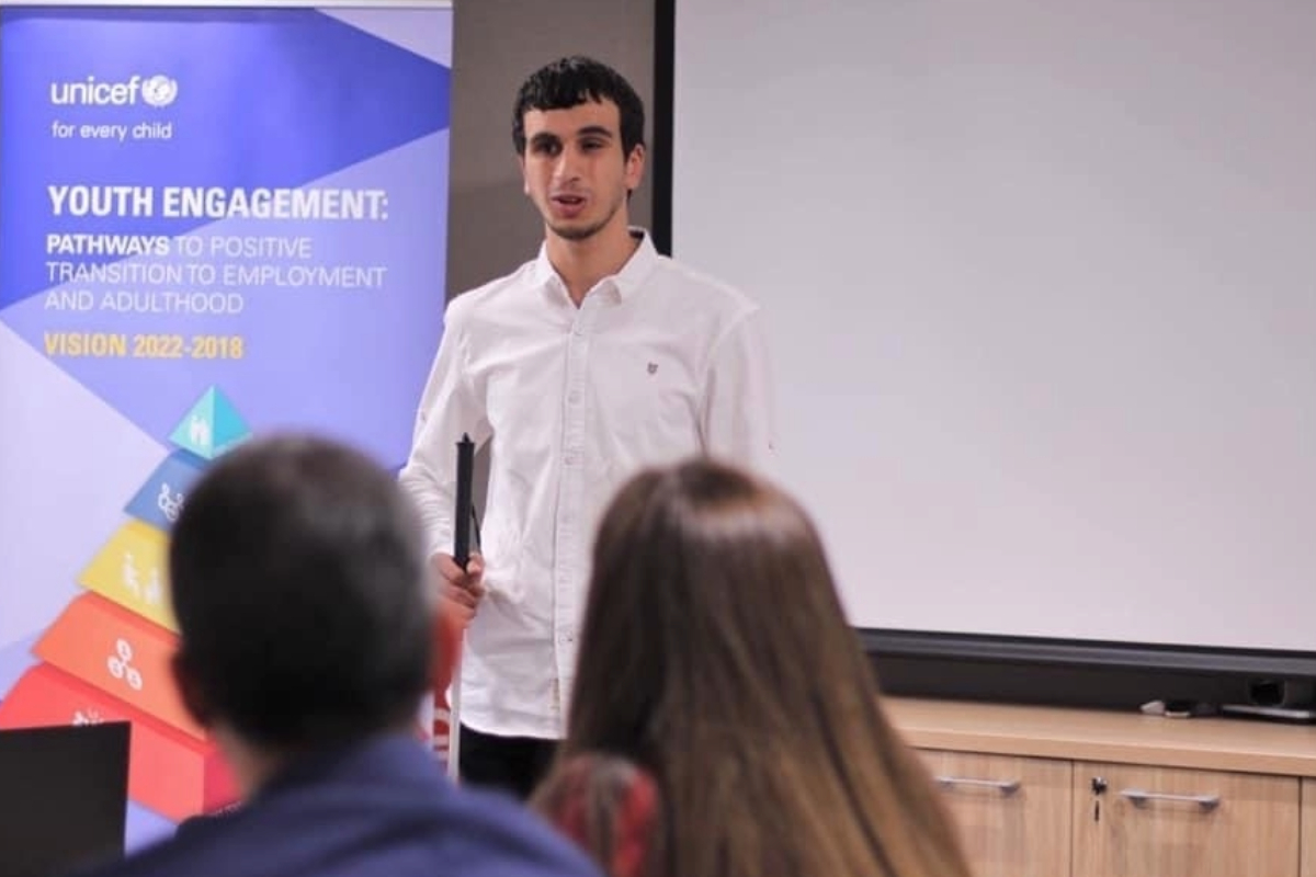 Hasan speaking at a UNICEF youth engagement event, inspiring positive transitions for young people