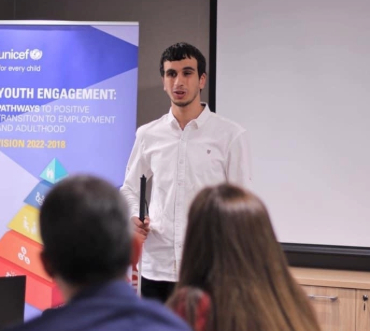 Hasan speaking at a UNICEF youth engagement event, inspiring positive transitions for young people